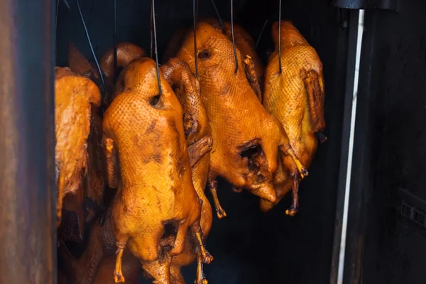 Smoked ducks hangind on peg — Stock Photo, Image