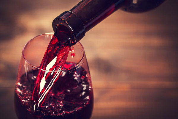 Pouring red wine into glass