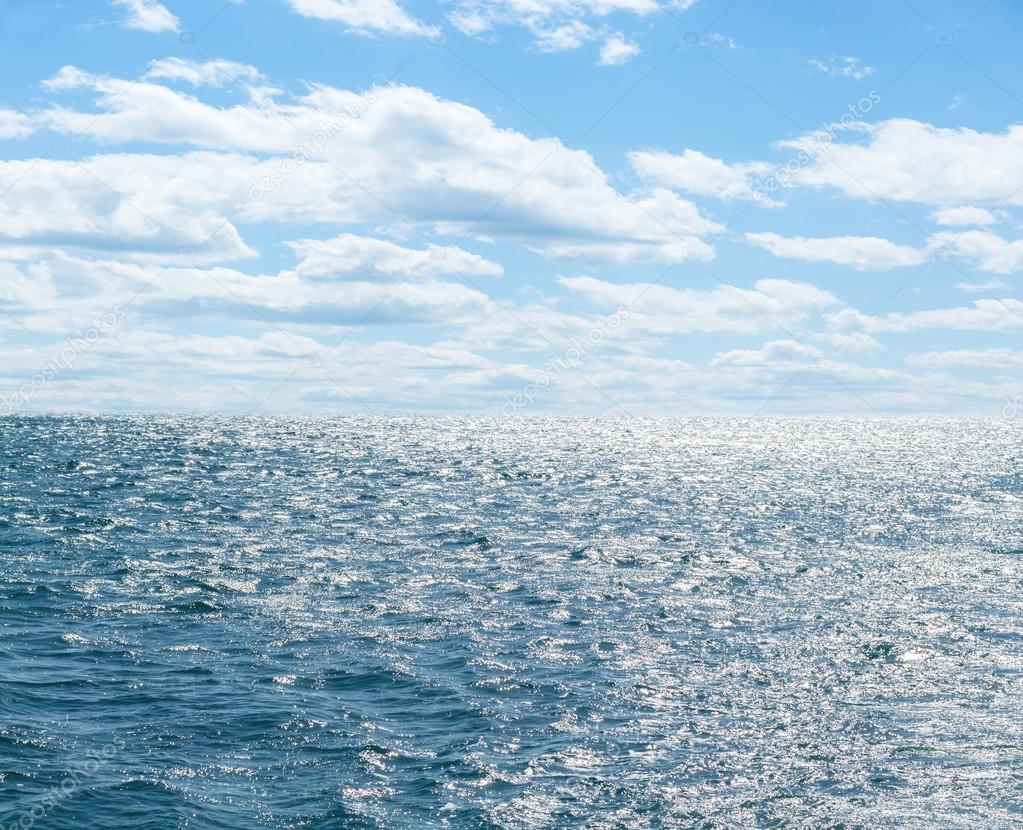 Blue sea with cloudy sky