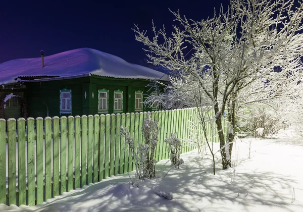 Old country house at winter evening — Stock Photo, Image