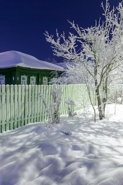 Old country house at winter evening — Stock Photo, Image