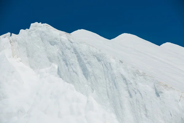 Pico de nieve blanca contra el cielo — Foto de Stock