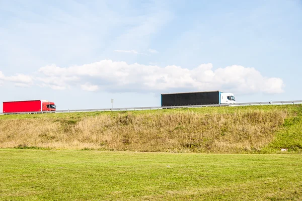 Trucks on the rural road — Stock Photo, Image