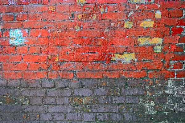 Textura erosionada de la vieja pared de ladrillo marrón oscuro y rojo manchado, bloques gruesos medio pintados — Foto de Stock