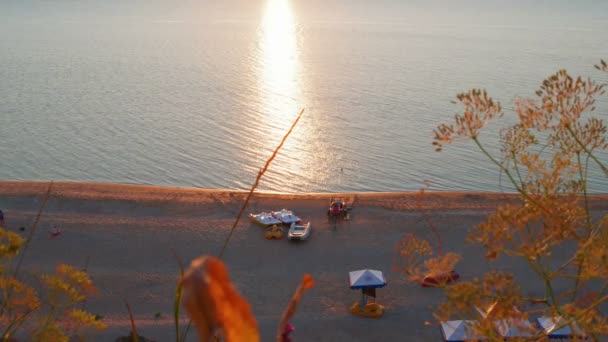 Sunset beach with recreational boats — Stock Video