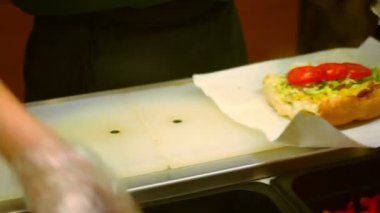 Fast food, şeffaf glowes prparing sandviç