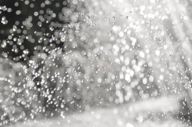 Ufuk su damlaları ve bulanık nokta ışık üstünde siyah arka plan, levitating çeşme çalışma