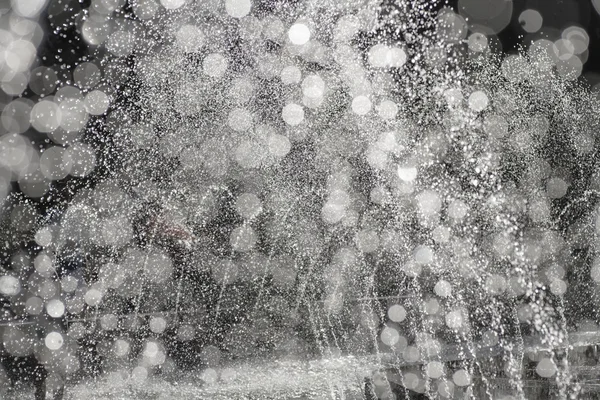 Schwarze und weiße Wassertropfen verschwommenes Bokeh-Licht Hintergrund — Stockfoto