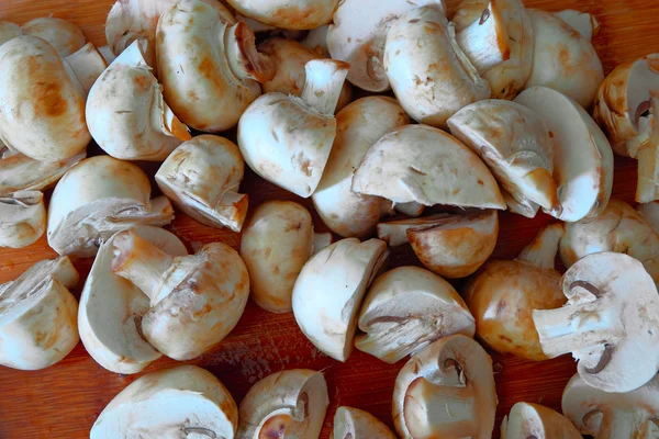 White raw champignon closeup on a wooden table. Above view of  group  mushrooms — Stock Photo, Image