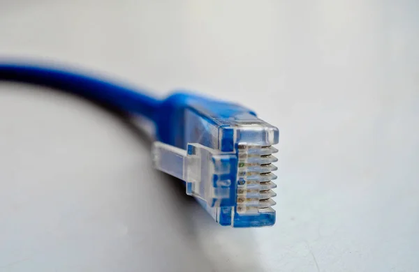 Macro cross section front angle view of blue RJ45 CAT6 shielded network data internet cable connector on gray, copyspace — Stock Photo, Image