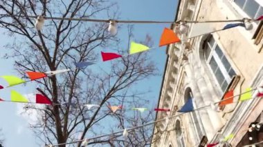 Carnival Garland with Flags. Decorative Party Pennants for Celebration, Festival or Fair Decoration. Hanging Flags, Bunting Flags,Triangle Fabrics Hanging on the Rope looking up slomo