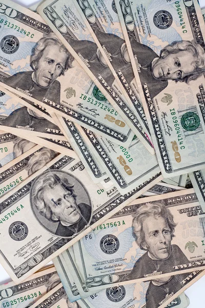 Muitas notas de dólar dispostas de forma caótica, fundo — Fotografia de Stock