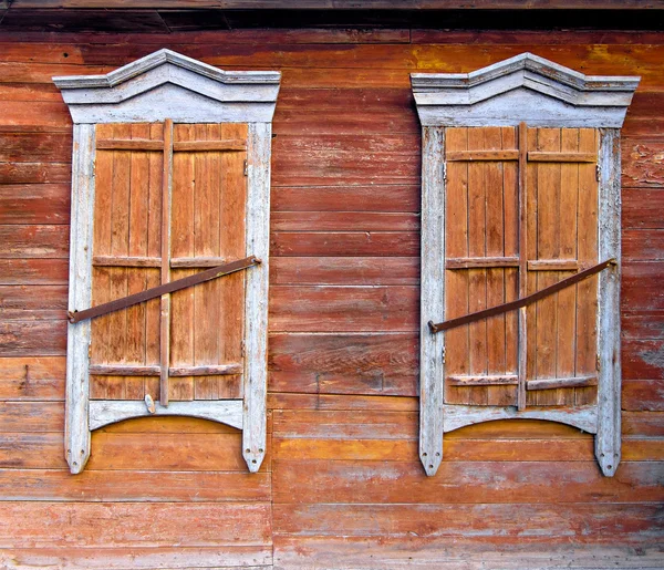 Zwei verwitterte Fenster einer alten Hütte in Russland — Stockfoto