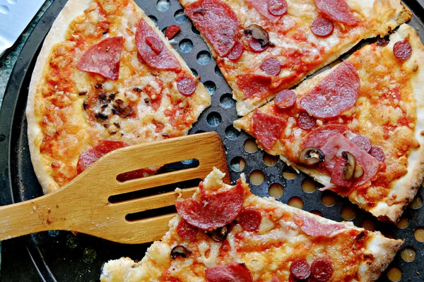 Supreme Pizza. A Pepperoni pizza on a plate with wooden shovel — Stock Photo, Image