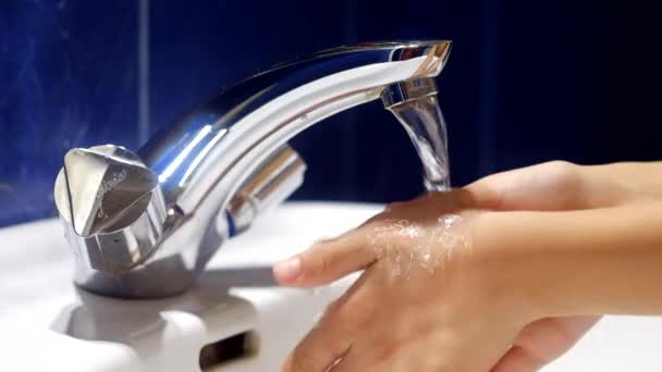 Boy switch tap on and wash his hands — Stock Video