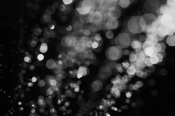 Gotas de agua desenfocadas vuelan flotando en el aire sobre fondo negro, imagen abstracta borrosa bokeh — Foto de Stock