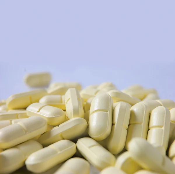 Heap of yellow pills and a lot of copyspace — Stock Photo, Image