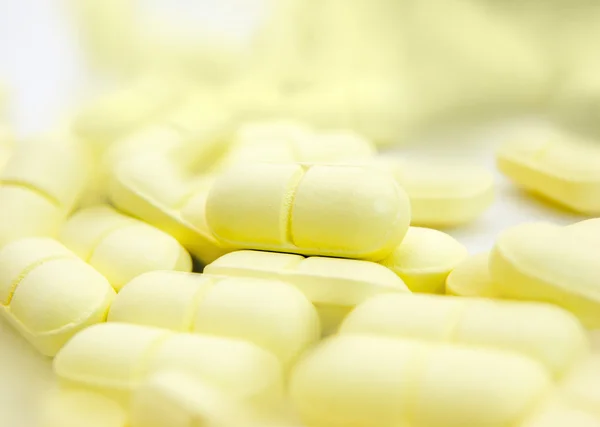 Macro of yellow pills — Stock Photo, Image