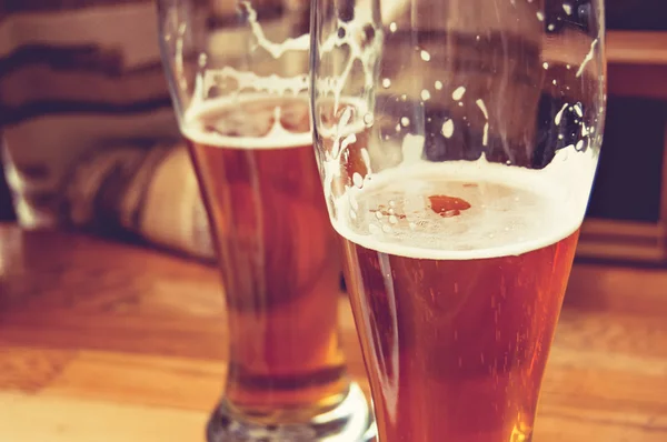 Half-full glasses of beer toned image — Stock Photo, Image