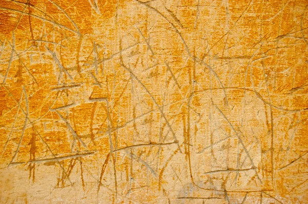 Scratched cement wall painted in orange — Stock Photo, Image