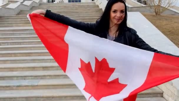 Portrait of a brunette girl with Canadian flag  outdoors — Stock Video