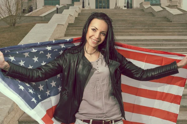 Young happy women with us flag outdoors smiling widely — Stock Photo, Image