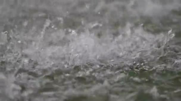 Eau éclaboussures sur la surface de l'étang lorsque la pluie tir caméra à grande vitesse 