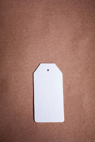 White Paper label on a brown craft paper background — Stock Photo, Image