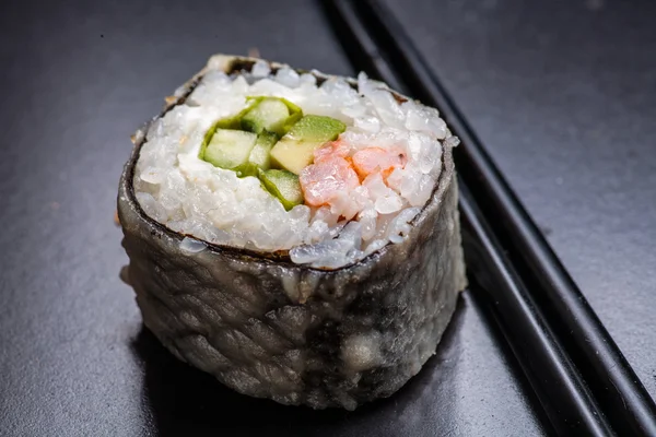 Macro of sushi served on black with reflection — Stock Photo, Image