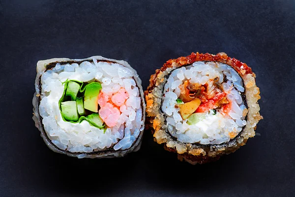 Two colorful sushi on black with copyspace — Stock Photo, Image