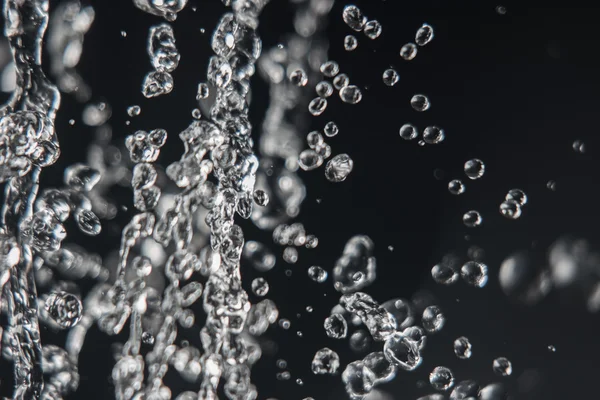 Levitation of water drops on black with copy space — Stock Photo, Image
