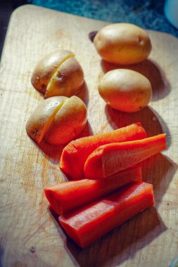 Genç patates ve havuç pices içinde ahşap arka plan üzerinde