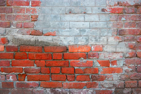 Red brick wall with part coverd with plaster — Stock Photo, Image