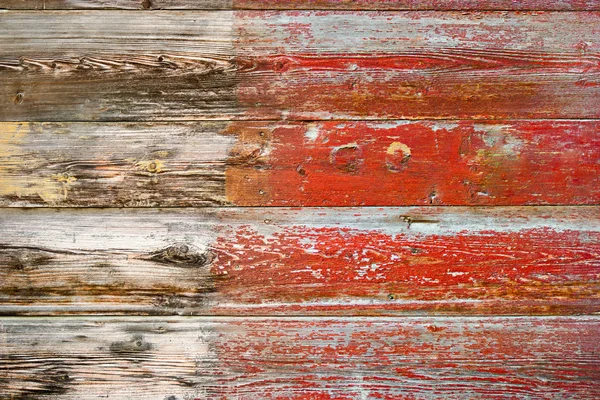 Weathered plank half painted in red color — Stock Photo, Image