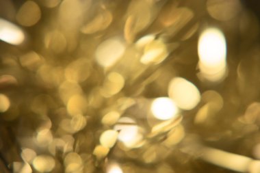 Altın bokeh mutlu yeni yıl veya xmas arka plan için hafif bulanıklık. Noel ışıkları döngüsel yansımalar