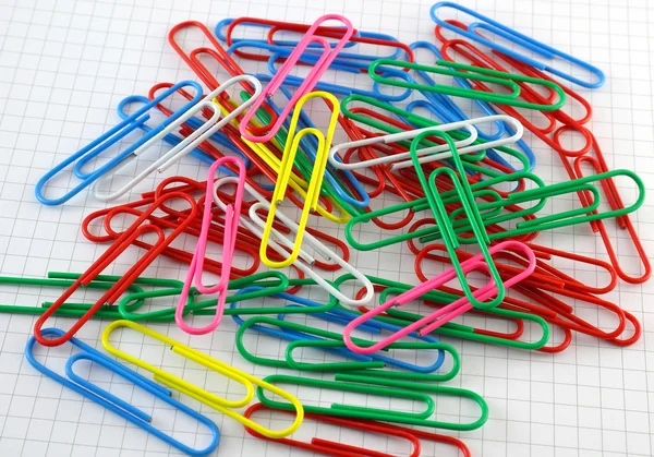 Color clips on checked paper — Stock Photo, Image