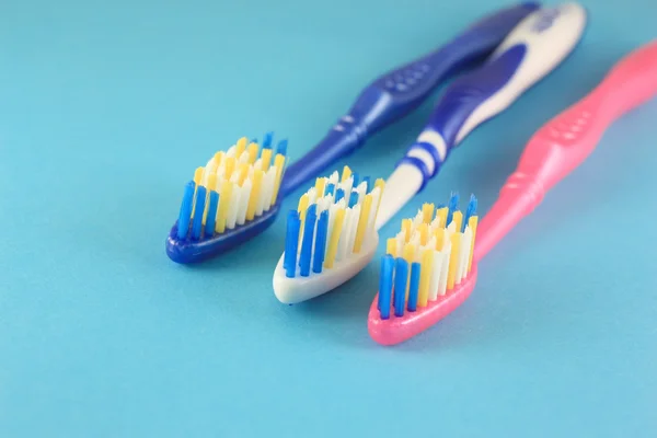 Tooth-brushes over blue — Stock Photo, Image