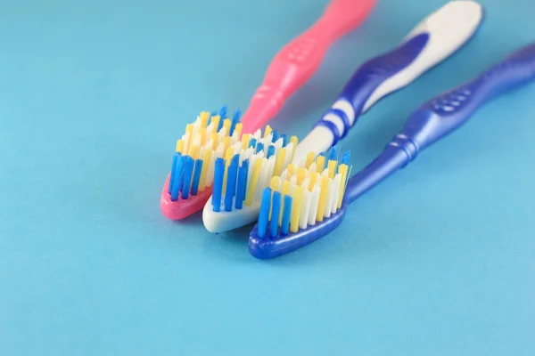 Tooth-brushes over blue — Stock Photo, Image