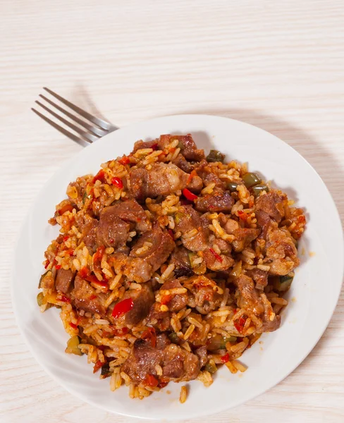 Ris med kött och grönsaker på tallriken — Stockfoto