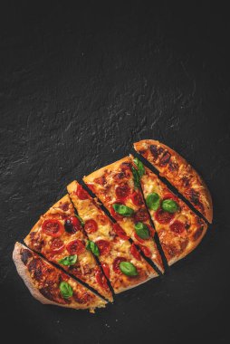 Mozzarella peynirli düz ekmekli pizza, domates, biber, baharat ve taze fesleğen. İtalyan pizzası. Koyu gri arka planda Pizza Margherita ya da Margarita