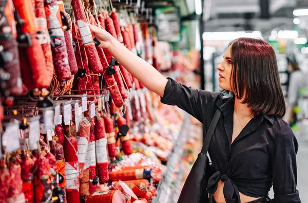 Mujer Joven Elige Salchicha Salami Supermercado — Foto de Stock