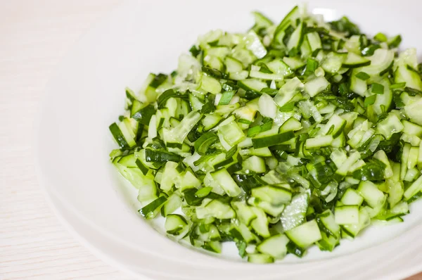 Green vegetable salad of cucumbers, spring onion — Stock Photo, Image