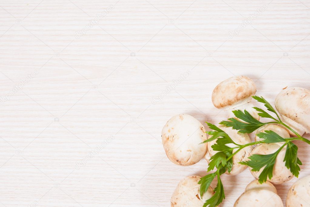 Food background of fresh mushrooms at the wooden board with copy space