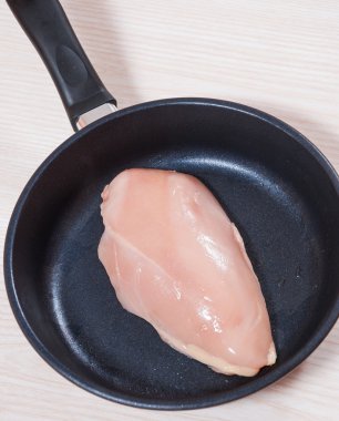 bir tavada çiğ tavuk göğsü