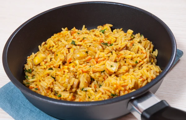 Rice with mushrooms in a frying pan — Stock Photo, Image