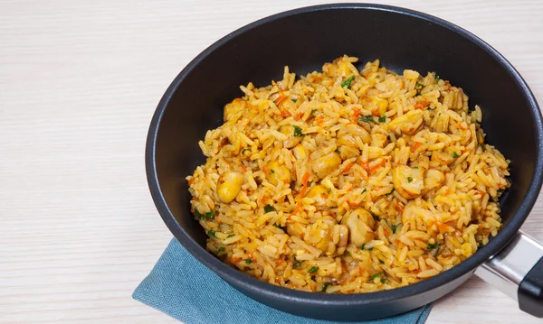 Rice with mushrooms in a frying pan — Stock Photo, Image