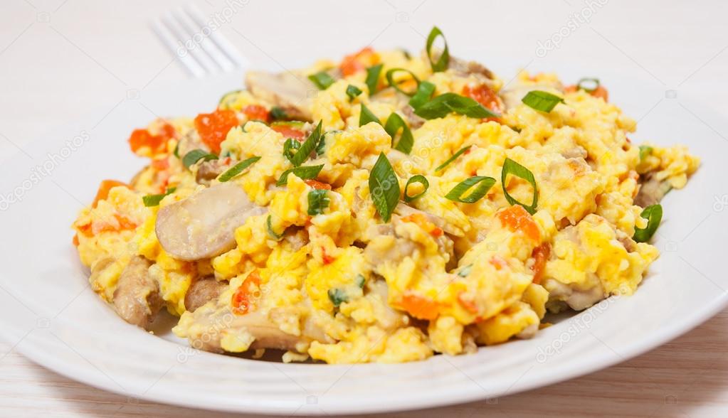 Scrambled eggs with mushrooms and vegetables Stock Photo by ©semenovp