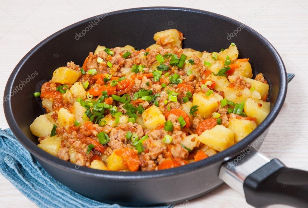 stewed potato with minced meat in a frying pan