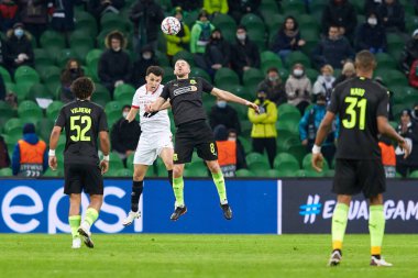 Krasnodar, Rusya - NOVEMBER 24, 2020: FC Krasnodar takımından Yuri Gazinskiy, FC Krasnodar ve Sevilla FC arasında oynanan UEFA Şampiyonlar Ligi karşılaşmasında Sevilla FC ile top mücadelesi verdi.