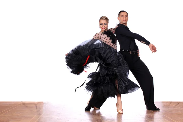 Latino dancers in ballroom against white background — Stock Photo, Image